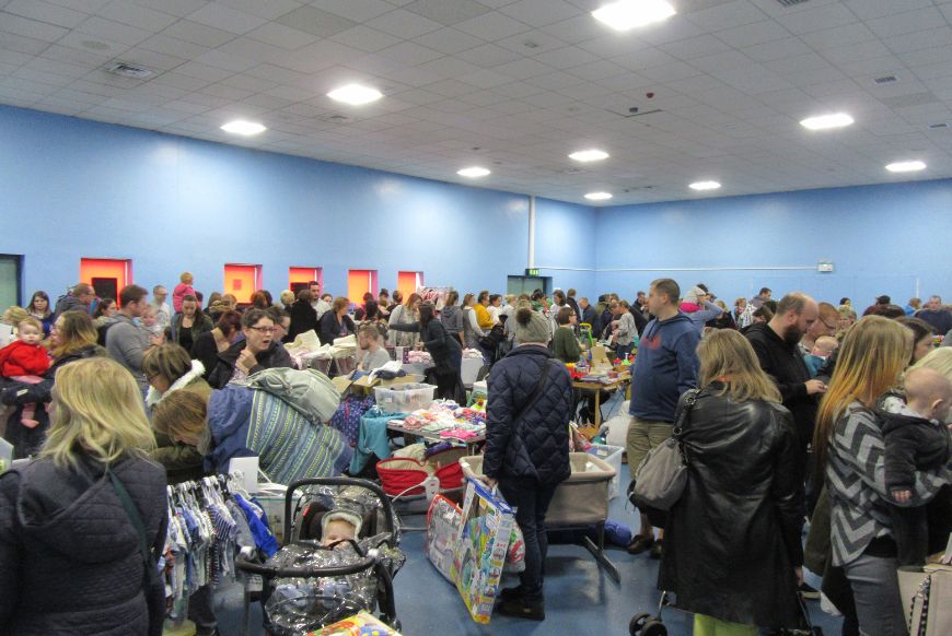 a hall full of people and stalls